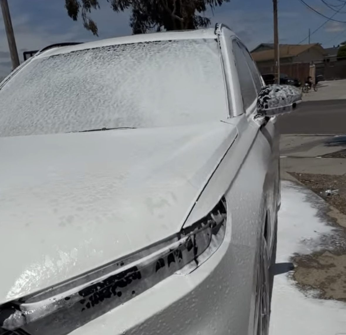 SUV covered in foam during a wash
